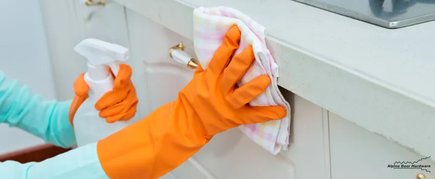 ADH - Woman cleaning to spruce up kitchen cabinet doors